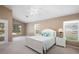 Comfortable main bedroom featuring a large window, vaulted ceiling, and stylish furniture at 1969 Crystal Downs Ct, Oviedo, FL 32765