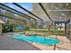 Relaxing screened-in pool area with a waterfall feature and a tranquil view of the golf course at 1969 Crystal Downs Ct, Oviedo, FL 32765