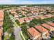 A community with tile roofs, tree-lined streets, and manicured lawns showcasing curb appeal at 1978 Fishtail Fern Way, Ocoee, FL 34761