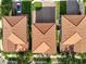 An aerial view showing roof tile, driveways, and landscaping of neighboring properties at 1978 Fishtail Fern Way, Ocoee, FL 34761