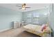 Cozy bedroom featuring a ceiling fan, desk, and natural light from two large windows at 1978 Fishtail Fern Way, Ocoee, FL 34761