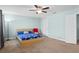 Light and airy bedroom boasting a modern bed frame and an adjacent closet door at 1978 Fishtail Fern Way, Ocoee, FL 34761