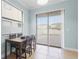 Cozy dining area with a modern table set and sliding glass doors to backyard at 1978 Fishtail Fern Way, Ocoee, FL 34761