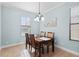 Bright dining room with a chandelier, tile flooring and natural light at 1978 Fishtail Fern Way, Ocoee, FL 34761