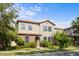 Charming two-story home featuring a stone facade, terracotta roof, and lush landscaping at 1978 Fishtail Fern Way, Ocoee, FL 34761