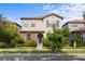 Charming two-story home featuring a stone facade, terracotta roof, and lush landscaping at 1978 Fishtail Fern Way, Ocoee, FL 34761