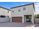 Two-story home featuring a brown garage door, tile roof, and brick driveway for curb appeal at 1978 Fishtail Fern Way, Ocoee, FL 34761
