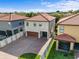 Aerial view of a two-story home featuring a tile roof, brick driveway, and well-maintained landscaping at 1978 Fishtail Fern Way, Ocoee, FL 34761