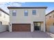 Two-story home featuring a brown garage door, tile roof, and brick driveway at 1978 Fishtail Fern Way, Ocoee, FL 34761
