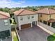 Aerial view of a two-story home with a tile roof, brick driveway, and an attached garage at 1978 Fishtail Fern Way, Ocoee, FL 34761