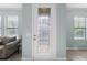 Bright foyer with decorative front door, tile flooring, and neutral paint at 1978 Fishtail Fern Way, Ocoee, FL 34761
