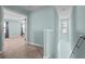 Upstairs hallway leading to carpeted bedroom and stairs at 1978 Fishtail Fern Way, Ocoee, FL 34761