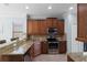 Beautiful kitchen featuring granite countertops, stainless steel appliances, and ample wood cabinetry at 1978 Fishtail Fern Way, Ocoee, FL 34761