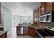 Well-equipped kitchen offering stainless steel appliances, granite countertops, and seamless flow into adjacent dining area at 1978 Fishtail Fern Way, Ocoee, FL 34761