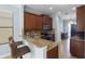 Stylish kitchen boasts granite countertops, stainless steel appliances, breakfast bar, and wood cabinetry for a modern look at 1978 Fishtail Fern Way, Ocoee, FL 34761