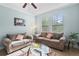 Cozy living room with comfortable sofas, glass coffee table, and abundant natural light at 1978 Fishtail Fern Way, Ocoee, FL 34761
