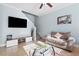 Stylish living room featuring a TV, comfortable sofa, and glass coffee table at 1978 Fishtail Fern Way, Ocoee, FL 34761