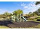 Community playground with multiple slides, swings, and padded ground surface for the community at 1978 Fishtail Fern Way, Ocoee, FL 34761