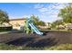 Community playground with a slide, swings, and a soft, padded ground surface for safety at 1978 Fishtail Fern Way, Ocoee, FL 34761