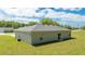 Home backyard featuring green grass, a sliding glass door and a view of the surrounding neighborhood at 2024 Sw 153Rd Loop, Ocala, FL 34473