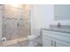 Well-lit bathroom featuring a glass shower, toilet, and granite-topped vanity with modern sink and fixtures at 2024 Sw 153Rd Loop, Ocala, FL 34473