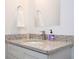 Close-up of a granite-topped vanity with a sink, a modern faucet, and accessories in a bathroom at 2024 Sw 153Rd Loop, Ocala, FL 34473