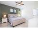 Spacious bedroom featuring a neutral color scheme, a ceiling fan, and a view to a modern bathroom at 2024 Sw 153Rd Loop, Ocala, FL 34473