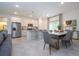 Open-concept kitchen and dining area with modern appliances, island seating, and stylish finishes at 2024 Sw 153Rd Loop, Ocala, FL 34473