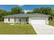 Charming single-story home with a well-manicured lawn and attached two-car garage at 2024 Sw 153Rd Loop, Ocala, FL 34473