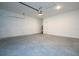 Well-lit garage space featuring concrete floor, water heater, and ample room for vehicles at 2024 Sw 153Rd Loop, Ocala, FL 34473