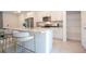 Detail of the kitchen island featuring granite countertops, stainless steel appliances, and white cabinets at 2024 Sw 153Rd Loop, Ocala, FL 34473