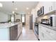 Modern kitchen boasts white cabinets, stainless steel appliances, and a spacious island with granite countertops at 2024 Sw 153Rd Loop, Ocala, FL 34473