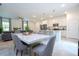 Open concept living space with a dining area that flows into a modern kitchen and cozy living room at 2024 Sw 153Rd Loop, Ocala, FL 34473