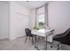 Well-lit office space features a white desk, two black chairs, and a window with natural light at 2024 Sw 153Rd Loop, Ocala, FL 34473