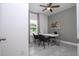Office with a ceiling fan, window, gray accent wall, and a modern white desk with two chairs at 2024 Sw 153Rd Loop, Ocala, FL 34473