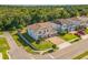 An aerial view showcasing a well-maintained home with lush landscaping and a brick-paved driveway in a serene neighborhood at 2539 Auburn Ridge Dr, Apopka, FL 32712