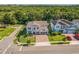 Aerial view of a home with manicured lawn and a brick paved driveway on a well-maintained street at 2539 Auburn Ridge Dr, Apopka, FL 32712