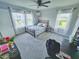 Bright bedroom with multiple windows, a comfortable bed, and a stylish desk area, creating a cozy retreat at 2539 Auburn Ridge Dr, Apopka, FL 32712