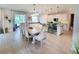 Open dining room with a large wooden table and chairs leading to a kitchen with a bar at 2539 Auburn Ridge Dr, Apopka, FL 32712