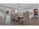 Bright and airy dining room with a long table, elegant chairs, and sliding glass doors to the backyard at 2539 Auburn Ridge Dr, Apopka, FL 32712