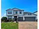 Beautiful two-story home showcasing a two-car garage and meticulously maintained landscaping at 2539 Auburn Ridge Dr, Apopka, FL 32712
