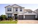 Beautiful two-story home featuring a manicured lawn and a two-car garage, offering curb appeal and ample parking at 2539 Auburn Ridge Dr, Apopka, FL 32712