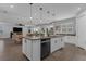 This is a kitchen island with a breakfast bar, black dishwasher and views into the dining and living areas at 2539 Auburn Ridge Dr, Apopka, FL 32712