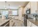 Bright kitchen featuring stainless steel appliances, an island with seating, and ample cabinet space at 2539 Auburn Ridge Dr, Apopka, FL 32712