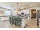 Open-concept kitchen boasts an island with seating, stainless steel appliances, and ample cabinetry at 2539 Auburn Ridge Dr, Apopka, FL 32712