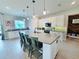 Bright kitchen featuring a large island with seating and modern appliances, perfect for cooking and entertaining at 2539 Auburn Ridge Dr, Apopka, FL 32712