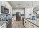 Spacious kitchen with stainless appliances, large island, white cabinets and gray backsplash at 2539 Auburn Ridge Dr, Apopka, FL 32712