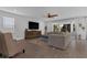 Open-concept living room featuring a comfortable sectional sofa, media center, and stylish decor at 2539 Auburn Ridge Dr, Apopka, FL 32712