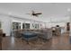 Spacious living room with a sectional sofa, ceiling fan, and sliding glass doors to the screened in patio at 2539 Auburn Ridge Dr, Apopka, FL 32712