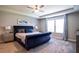 Beautiful main bedroom features a tray ceiling, large windows, and a tufted bed at 2539 Auburn Ridge Dr, Apopka, FL 32712